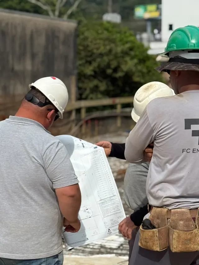 Profissionais da FC conferindo a planta da obra